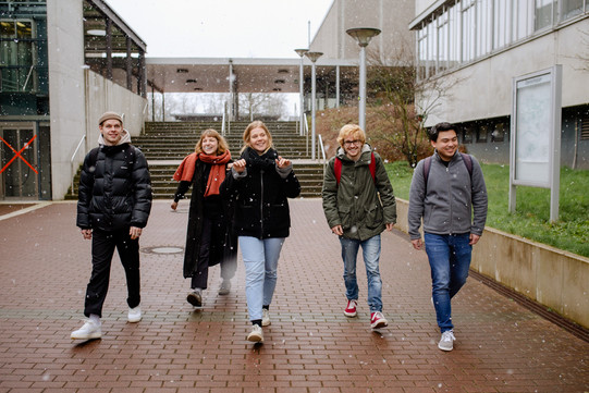 Studierende auf dem Campus Studierende laufen über den Campus.